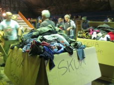 Volunteers sorting trash, recycling, and clothes at the skua sorting party.