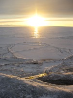 The sun setting over the sea ice.